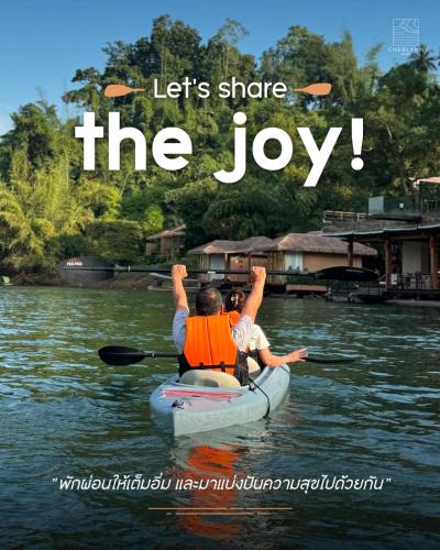 a man and a child in a kayak on the water at Cherlynn Resort in Ban Gaeng Cho