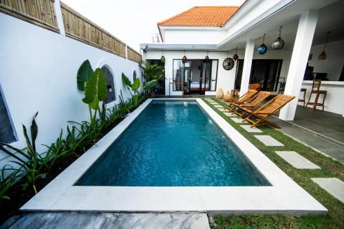 a swimming pool in the backyard of a house at YO Villa Canggu in Canggu