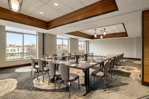 a conference room with a long table and chairs at Hotel Indigo Naperville Riverwalk by IHG in Naperville