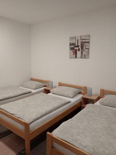 a group of four beds in a room at Apartment Marija in Slavonski Brod