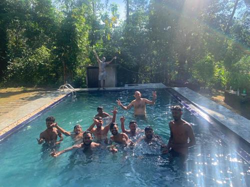 a group of people in a swimming pool at DIS Herbal Villa in Induruwa