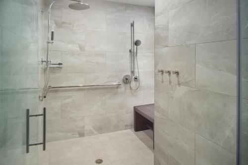 a bathroom with a shower with a glass door at The Westin Charlotte in Charlotte