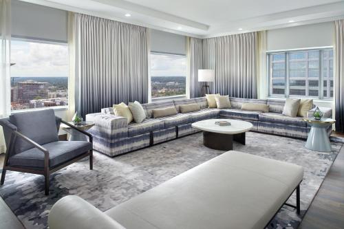 a living room with a couch and chairs and windows at The Westin Charlotte in Charlotte