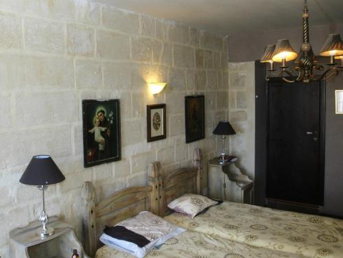 a bedroom with a bed and some pictures on the wall at Luciano Valletta Boutique in Valletta