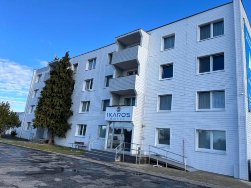 a white building with a sign that reads konglords at Aviator Garni Hotel Bratislava in Bratislava