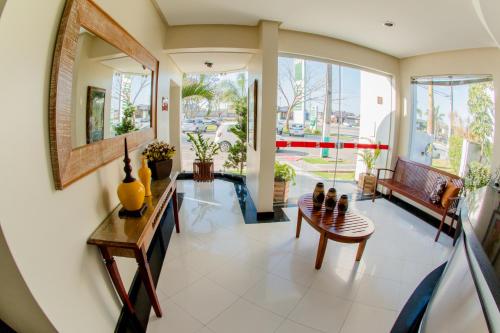 a large living room with a table and chairs at Hotel Oceania in Eunápolis