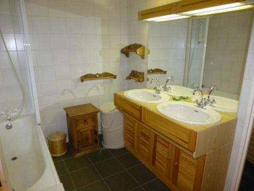 ein Badezimmer mit zwei Waschbecken und einem Spiegel in der Unterkunft Appartement skis aux pieds avec vue piste, 6 pers - FR-1-514-8 in Courchevel