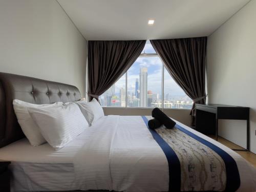a bedroom with a large bed with a large window at Vortex suites KLCC by Dela in Kuala Lumpur