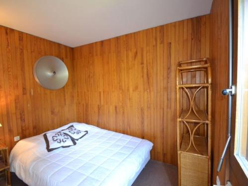 une chambre avec un lit et un mur en bois dans l'établissement Charmant appartement rustique à Courchevel, 5 pers, près des pistes - FR-1-514-29, à Courchevel