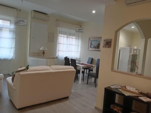 a living room with a white couch and a table at Affittacamere Lusitana Alloggi 2 in Foligno