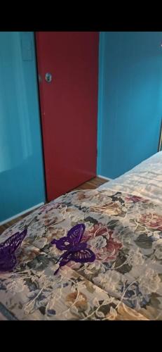 a bed with a comforter with butterflies on it at Choice of comfort in Hemet