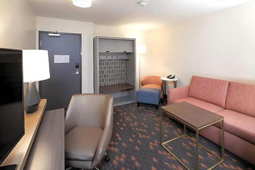 a living room with a couch and a table at Holiday Inn - Kalamazoo West by IHG in Kalamazoo