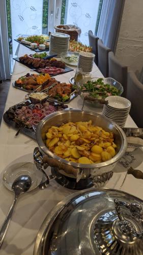 a table with a buffet of food on it at Hotel Restaurant Jägerhof in Braunschweig