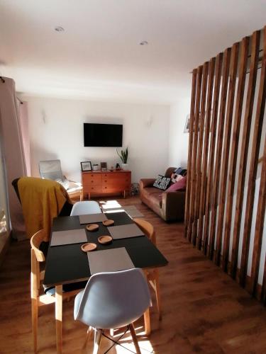 a living room with a table and a couch at Claires Cottage in Bethesda