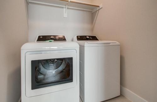 a washing machine and a dryer in a room at Comfort exceed in this 3 BR premium in Houston! in Houston