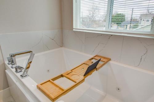 a bathroom with a sink and a mirror and a window at Comfort exceed in this 3 BR premium in Houston! in Houston