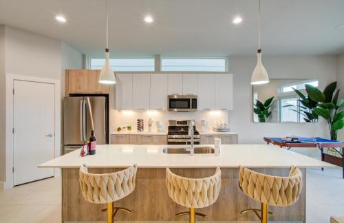 a kitchen with a large island with bar stools at Comfort exceed in this 3 BR premium in Houston! in Houston