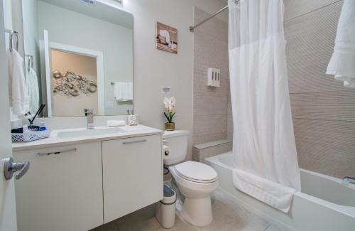 a bathroom with a toilet and a sink and a shower at Comfort exceed in this 3 BR premium in Houston! in Houston