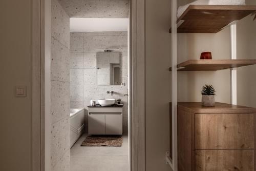 a small bathroom with a tub and a sink at Astarte Villas Bleu Del Mar Villa in Argasi