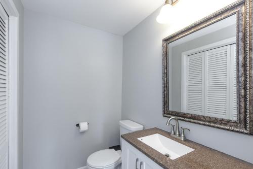 a bathroom with a sink and a mirror at 3 bed 2 bath pet friendly townhome in Londonderry