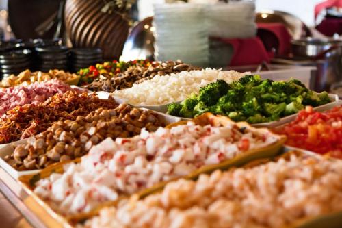 a buffet of different types of food on a table at Crowne Plaza Minneapolis West by IHG in Plymouth