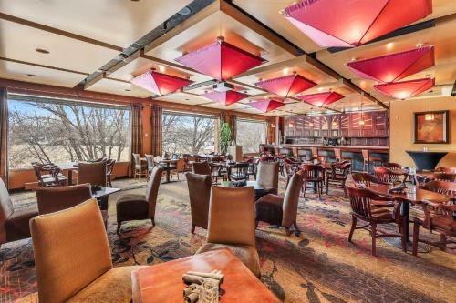 a restaurant with tables and chairs and a bar at Crowne Plaza Minneapolis West by IHG in Plymouth