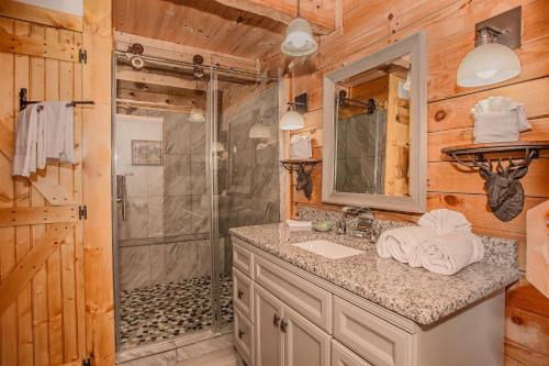 a bathroom with a shower and a sink at Sunset Ridge in Sevierville