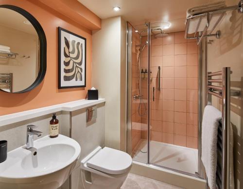 a bathroom with a toilet sink and a shower at master Cannon in London