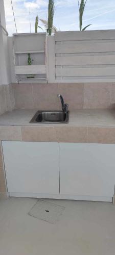 a kitchen with a sink and a counter top at Filina's Room 1 in Maltezana