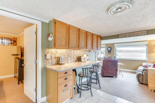 a kitchen with wooden cabinets and a counter top at Private Boat Dock Lakefront Cabin in Camdenton in Camdenton