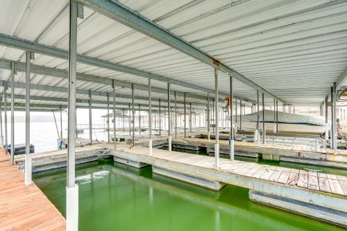 a large building with a pool of green water at Private Boat Dock Lakefront Cabin in Camdenton in Camdenton
