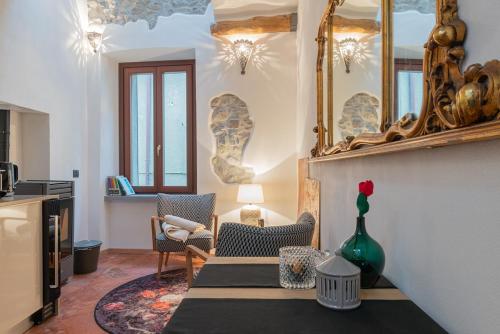 a living room with a table and a mirror at Tiny loft with Jacuzzi in Bellano