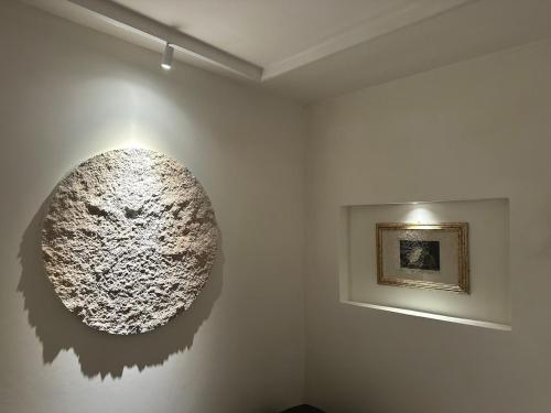 a large sculpture on a wall in a room at Suite del Pittore in Tivoli