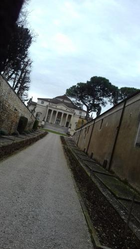an empty road in front of a large building at Stradella 5 in Vicenza