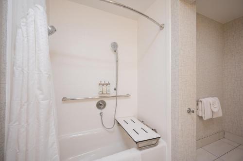 a bathroom with a shower and a white tub at Holiday Inn Express Grover Beach-Pismo Beach Area by IHG in Grover Beach