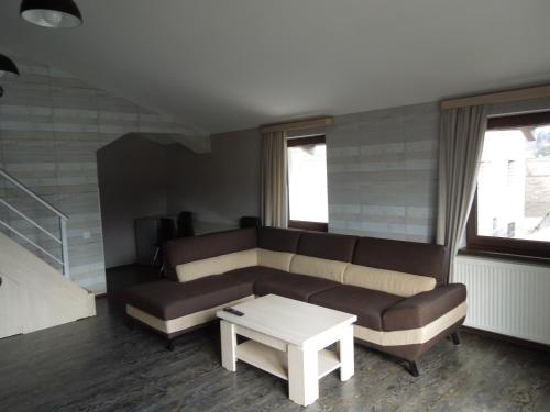 a living room with a couch and a coffee table at Family room in Bakuriani in Bakuriani