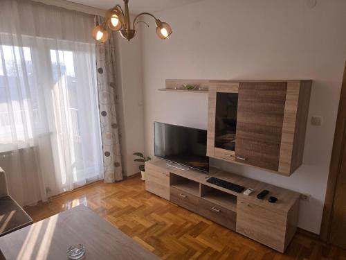 a living room with a flat screen tv on a wall at K&A apartman in Bijeljina