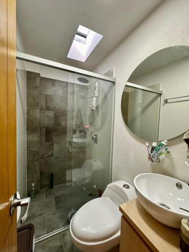 a bathroom with a shower and a toilet and a sink at Finca Amatista in Guarne