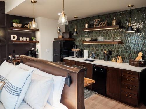 a kitchen with a bed in a room with a counter at Downtown Boise Sunset Ave Romantic Private Suite in Boise