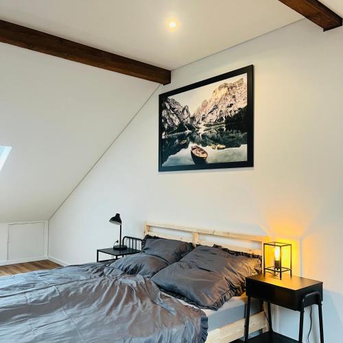 a bedroom with a bed and a picture on the wall at City Loft Apartment Bad Säckingen in Bad Säckingen