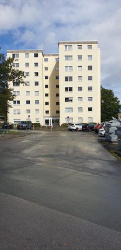 a large white building with cars parked in front of it at Life Modern, Smart Appartment Balkon in Plettenberg