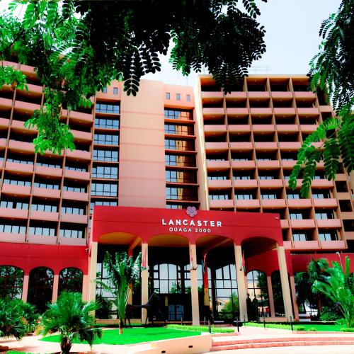 a large red building with a hotel at Lancaster Ouaga 2000 in Ouagadougou