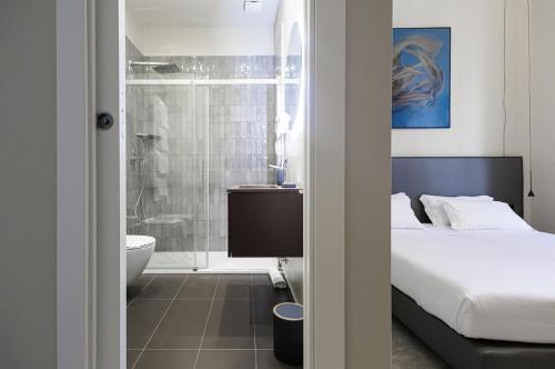 a bedroom with a bed and a bathroom with a shower at RV 2,0 Accommodations in Messina