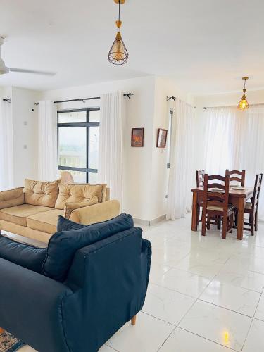 a living room with a couch and a table at Nyali Exquisite 2 bedroom behind City Mall-Swanky in Mombasa