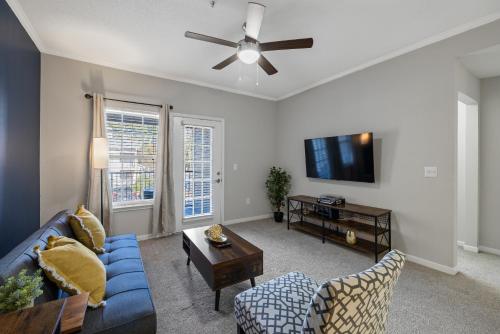 a living room with a blue couch and a tv at Charming 3BR Athens Abode Near UGA and Downtown in Athens