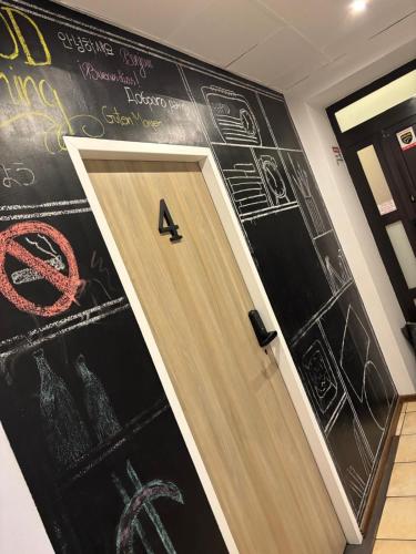 a room with a door with graffiti on the wall at Dream & HOSTEL - Central Station FaktVat in Kielce