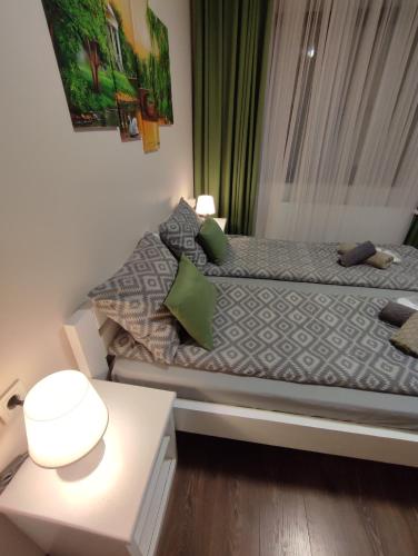 a small bedroom with a bed and a table at Карпатська Вершина in Yaremche