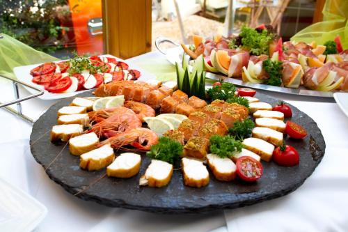 a plate of food with seafood and other foods on a table at Landgasthof Hotel Rössle in Steinenkirch
