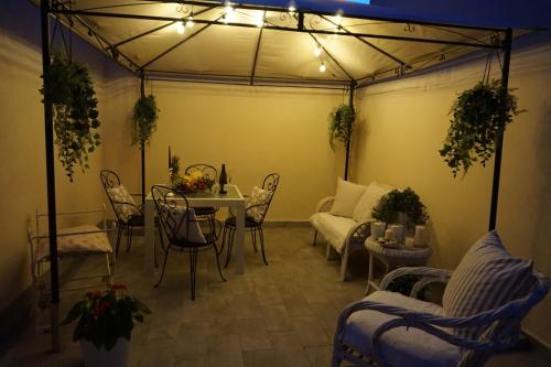 a living room with a couch and a table and chairs at Viareggio, Sweet home in Viareggio