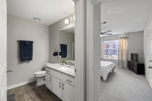 a bathroom with a toilet and a sink and a mirror at Charming3BR Home in Athens Georgia Prime Location in Athens